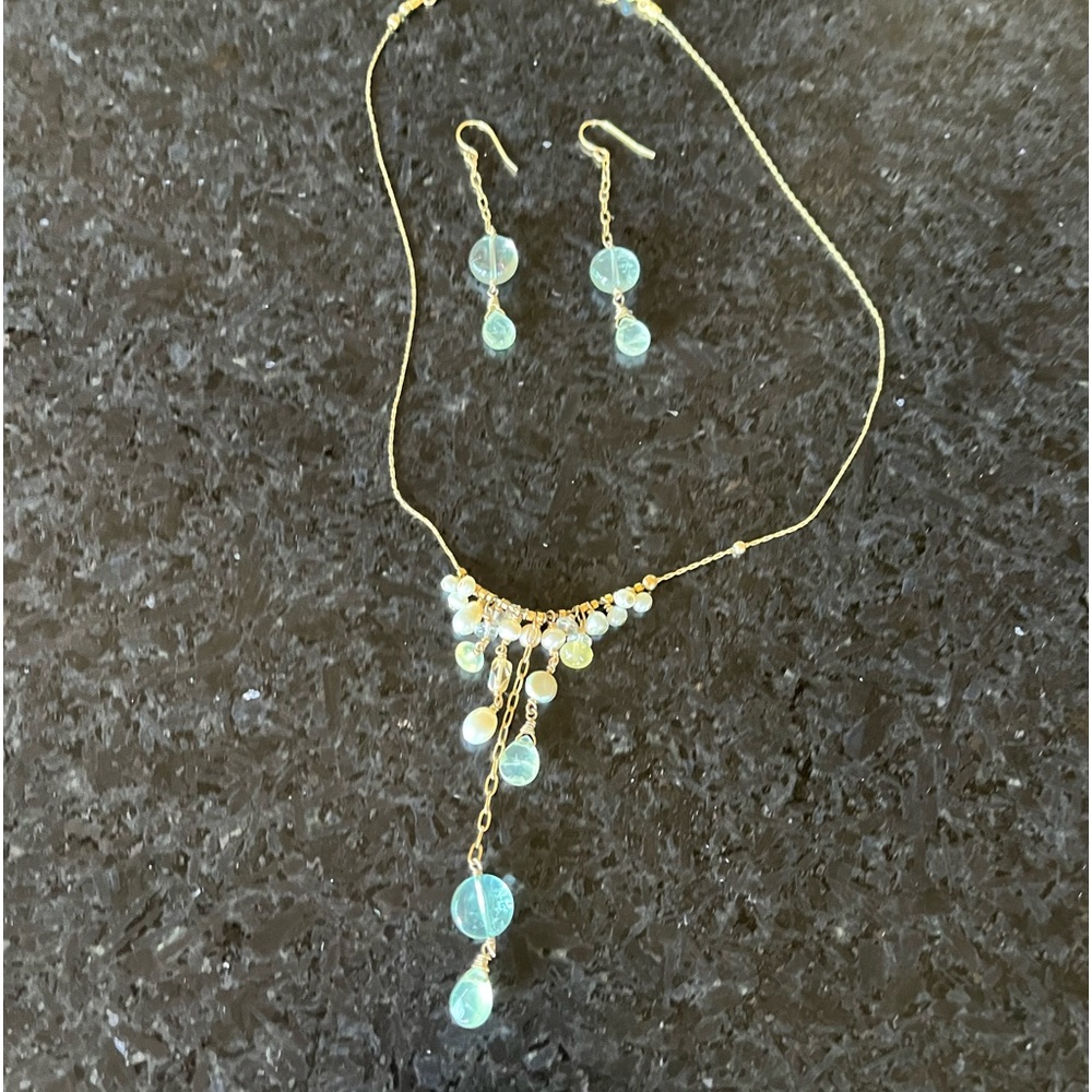 Gold pearl and light blue stone necklace and earring set.